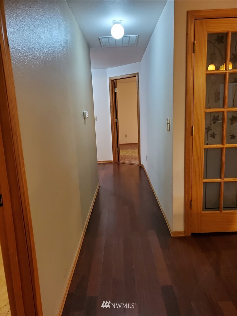 541 East Coulter Creek Road Belfair, WA 98528 - Photo 12 of 39 a view of a hallway with wooden floor