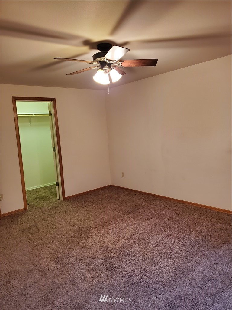 541 East Coulter Creek Road Belfair, WA 98528 - Photo 18 of 39 a view of a room with a mirror and a fan
