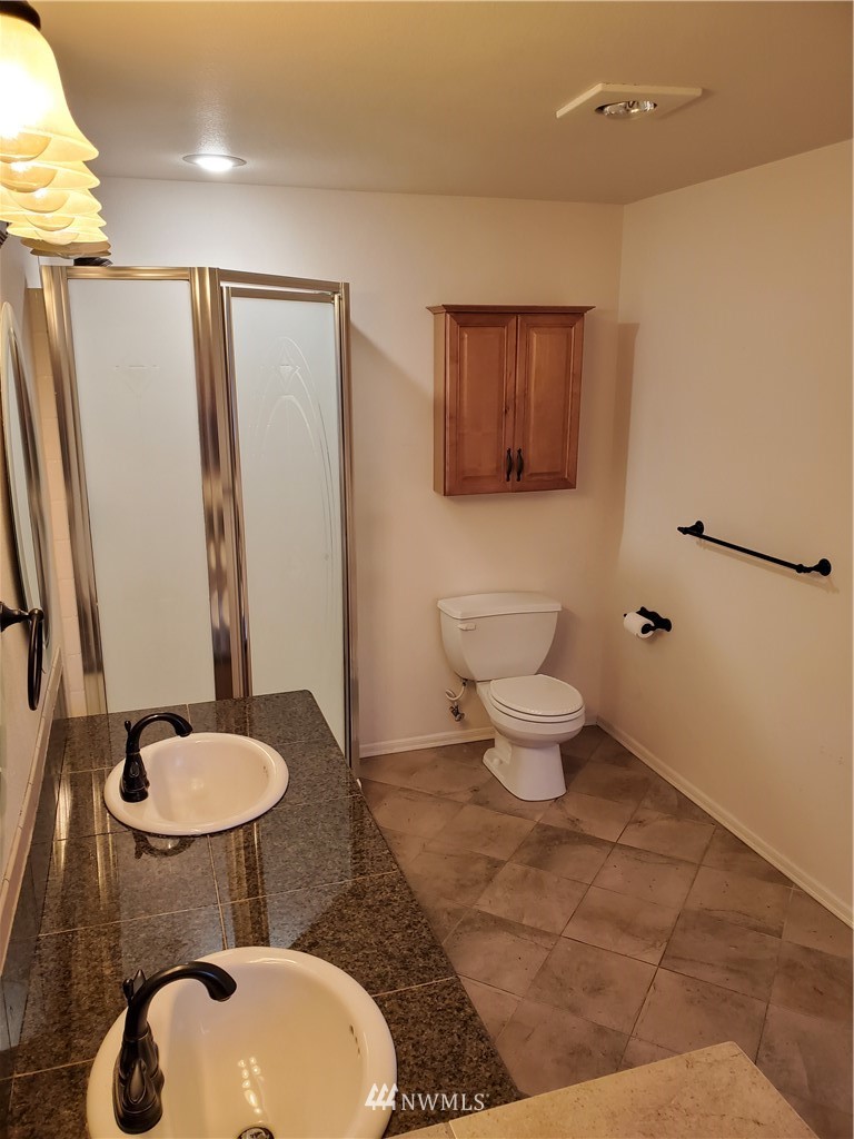 541 East Coulter Creek Road Belfair, WA 98528 - Photo 23 of 39 a bathroom with a toilet sink and mirror
