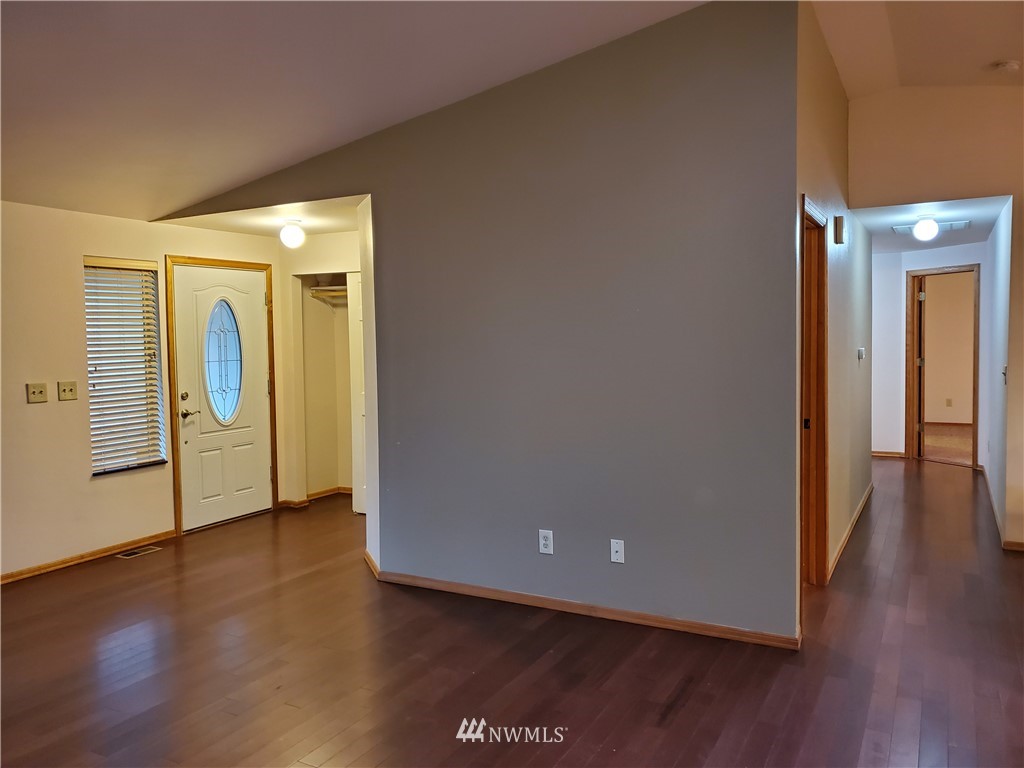 541 East Coulter Creek Road Belfair, WA 98528 - Photo 4 of 39 a view of a hallway with wooden floor