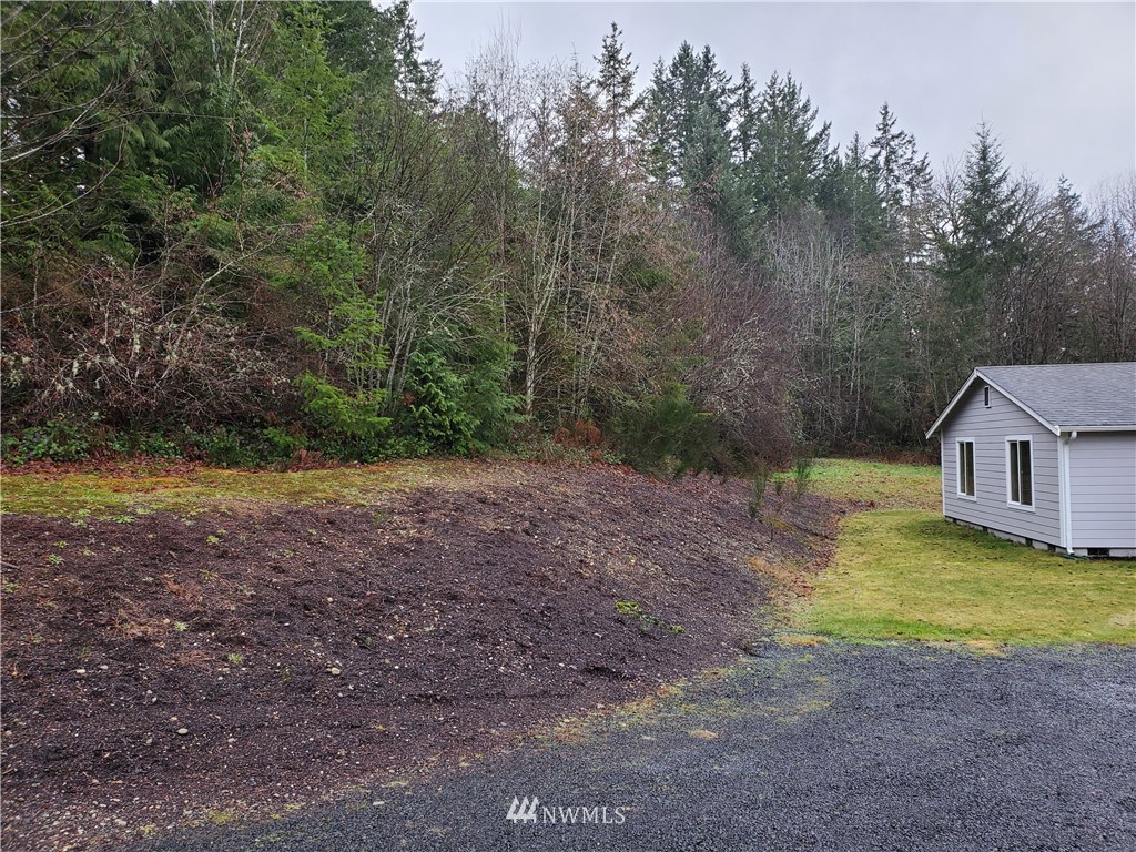 541 East Coulter Creek Road Belfair, WA 98528 - Photo 32 of 39 a view of a house with a yard