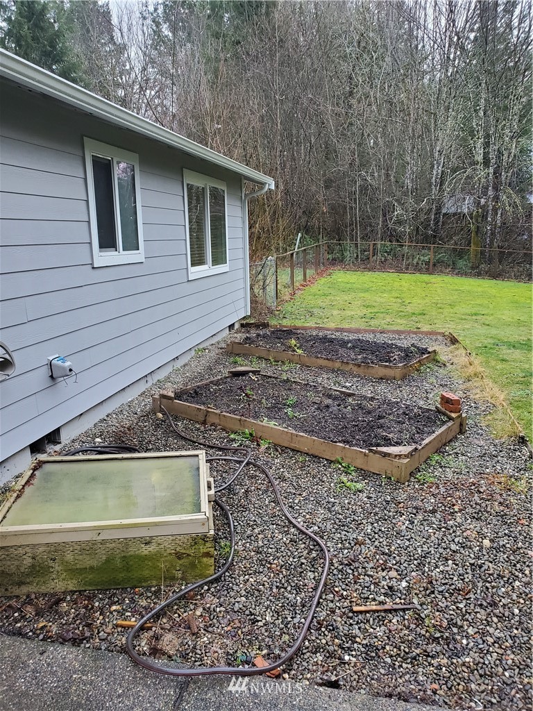 541 East Coulter Creek Road Belfair, WA 98528 - Photo 37 of 39 a view of a house with a yard