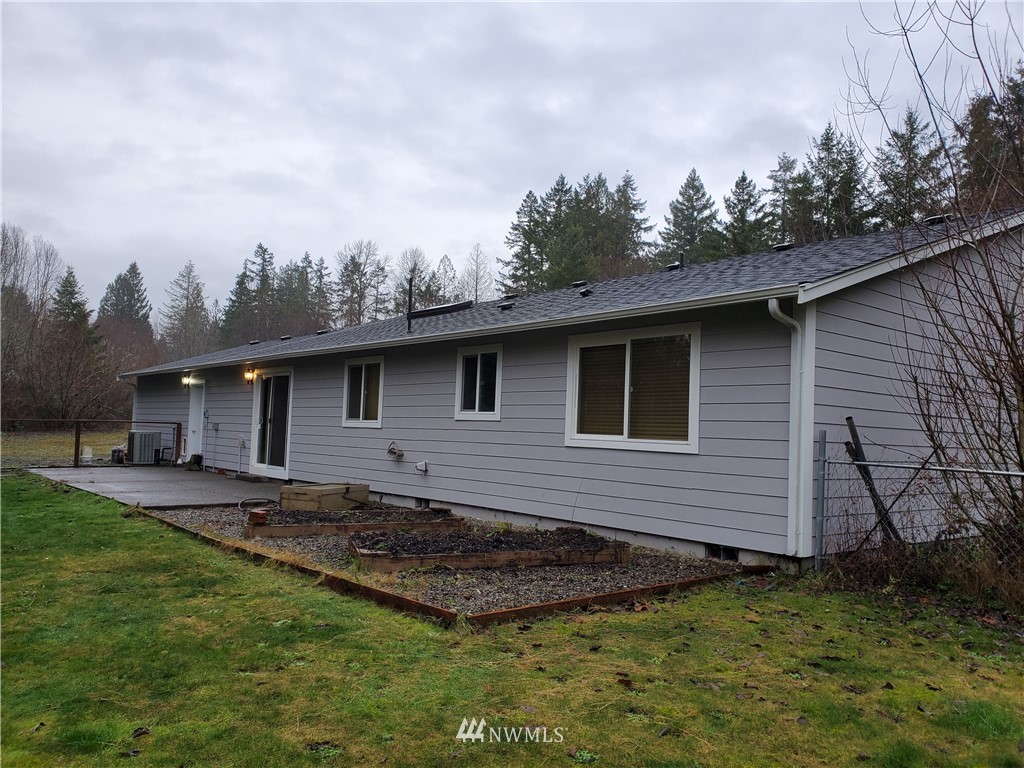 541 East Coulter Creek Road Belfair, WA 98528 - Photo 38 of 39 a view of a backyard with plants and large tree