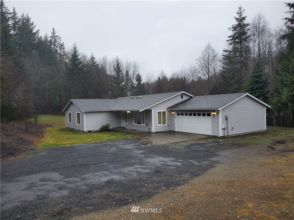 541 East Coulter Creek Road Belfair, WA 98528 - Photo 39 of 39 a house that is sitting in the middle of a field