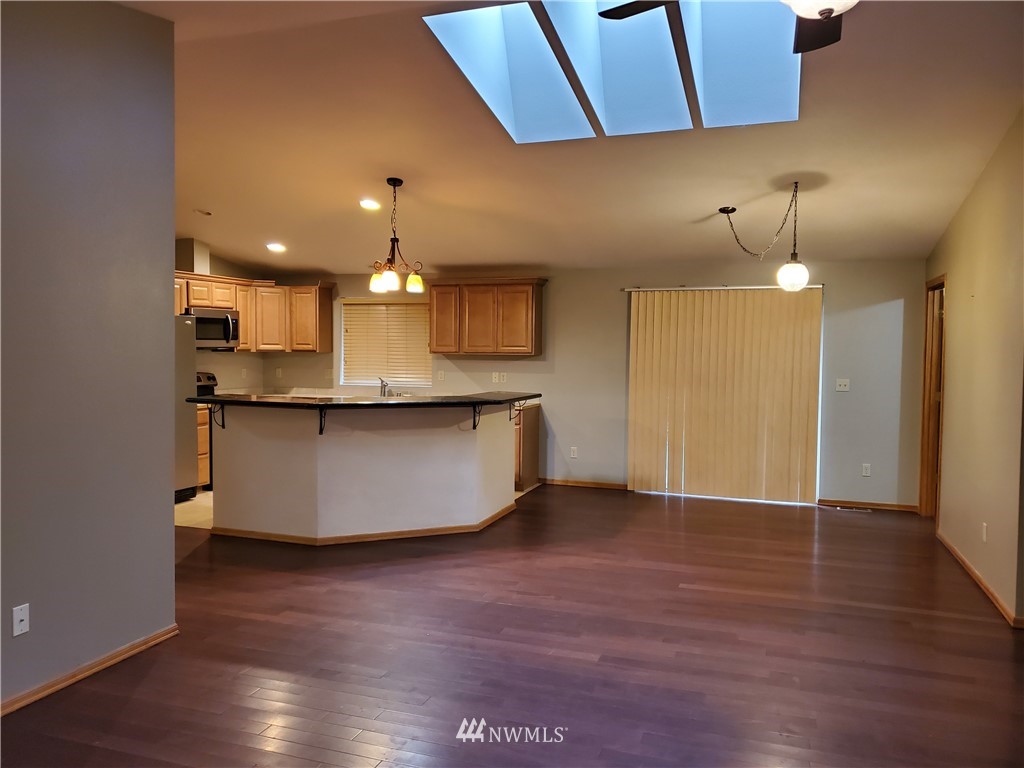 541 East Coulter Creek Road Belfair, WA 98528 - Photo 5 of 39 a view of a kitchen with a sink and chandelier