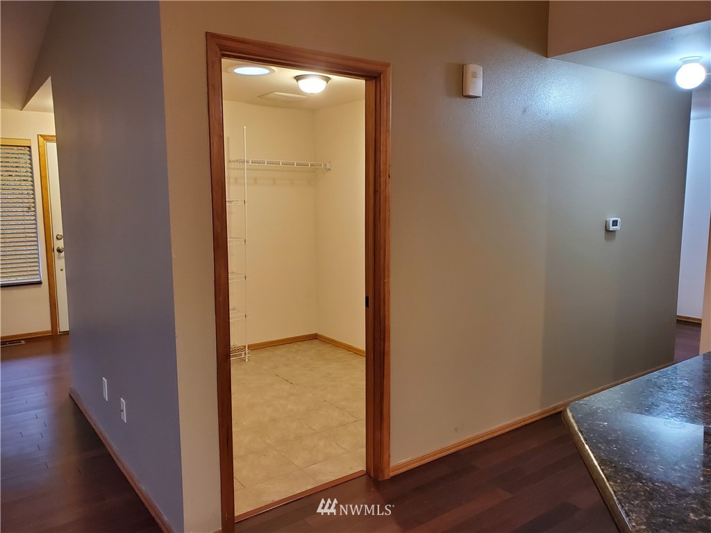 541 East Coulter Creek Road Belfair, WA 98528 - Photo 6 of 39 an empty room with wooden floor and a window