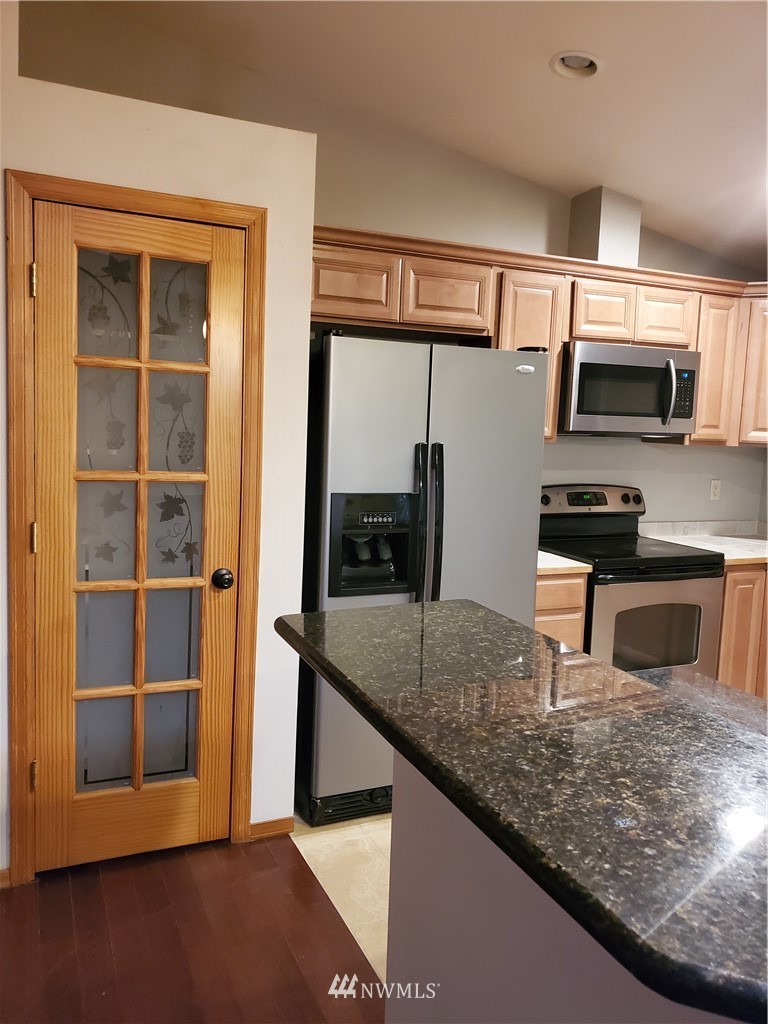 541 East Coulter Creek Road Belfair, WA 98528 - Photo 7 of 39 a kitchen with stainless steel appliances granite countertop a sink and a microwave
