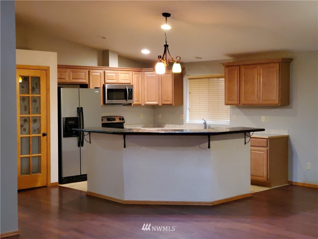 541 East Coulter Creek Road Belfair, WA 98528 - Photo 8 of 39 a kitchen with stainless steel appliances granite countertop a stove a sink and a refrigerator