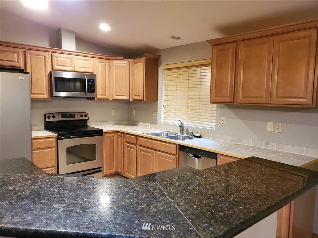 541 East Coulter Creek Road Belfair, WA 98528 - Photo 10 of 39 a kitchen with a sink stove top oven and microwave