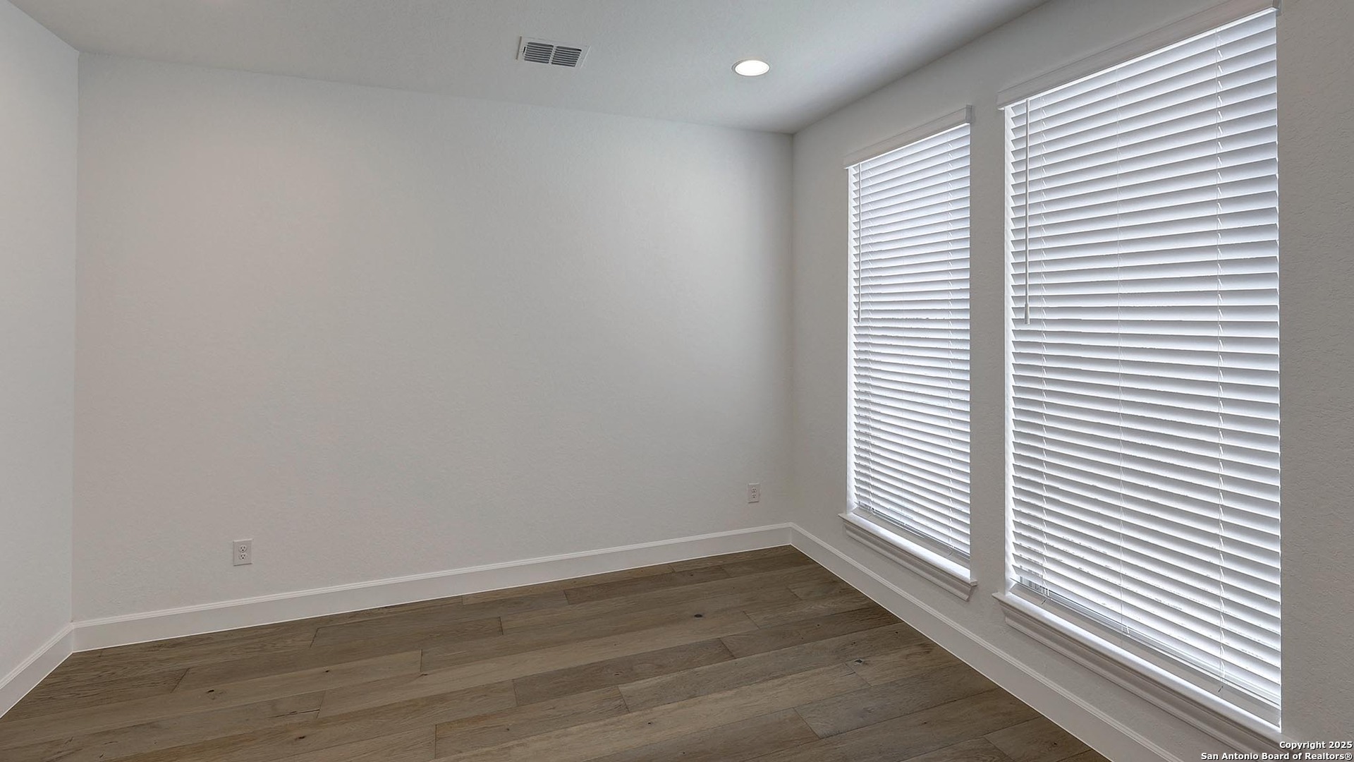 30 Enia Circle San Antonio, TX 78257 - Photo 6 of 27 an empty room with wooden floor