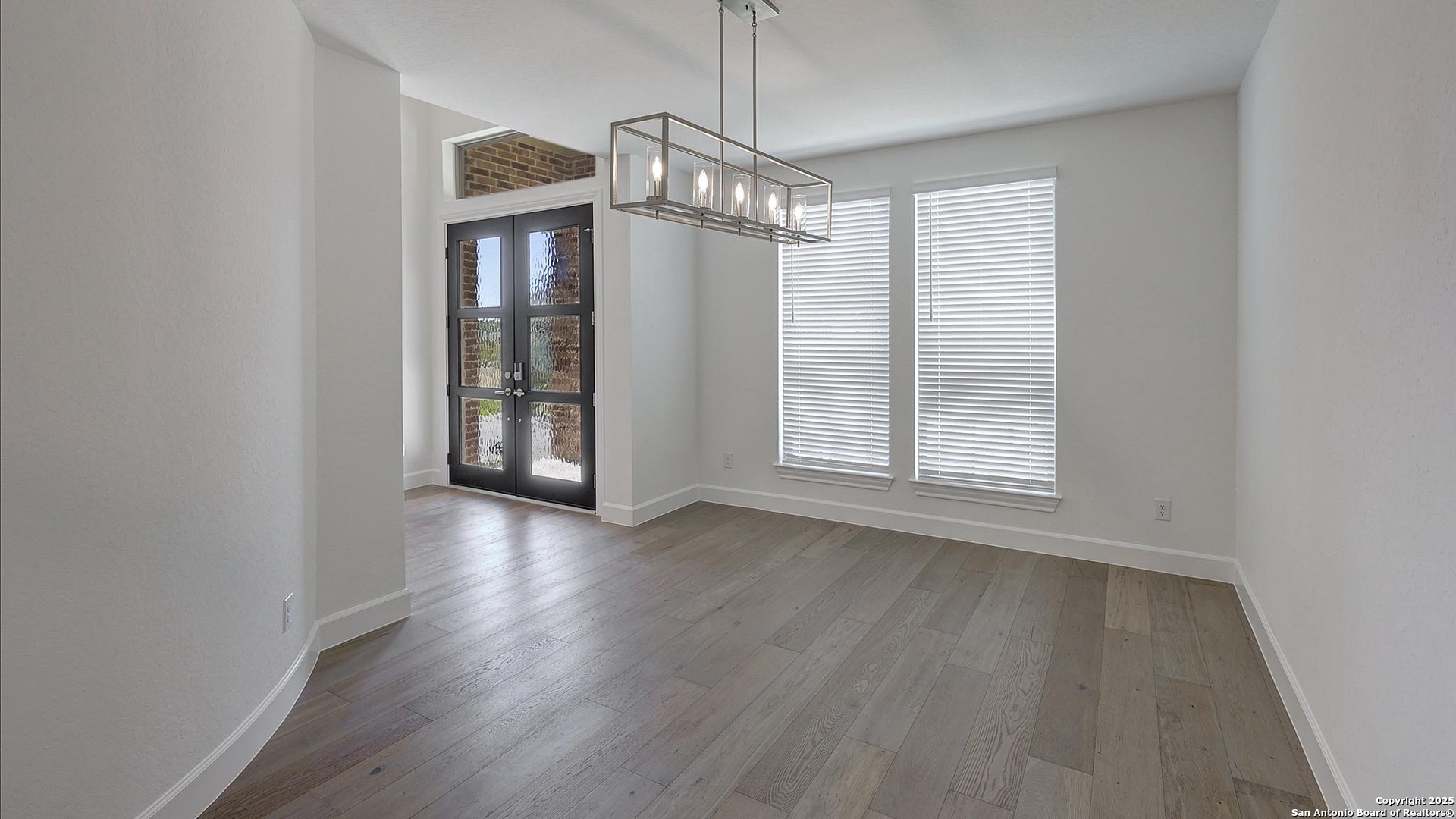 30 Enia Circle San Antonio, TX 78257 - Photo 9 of 27 a view of an empty room with wooden floor and a window