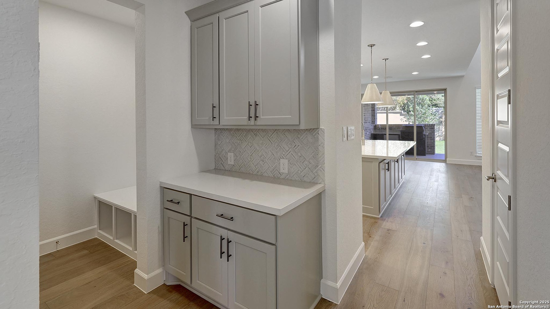 30 Enia Circle San Antonio, TX 78257 - Photo 10 of 27 a kitchen with cabinets and wooden floor