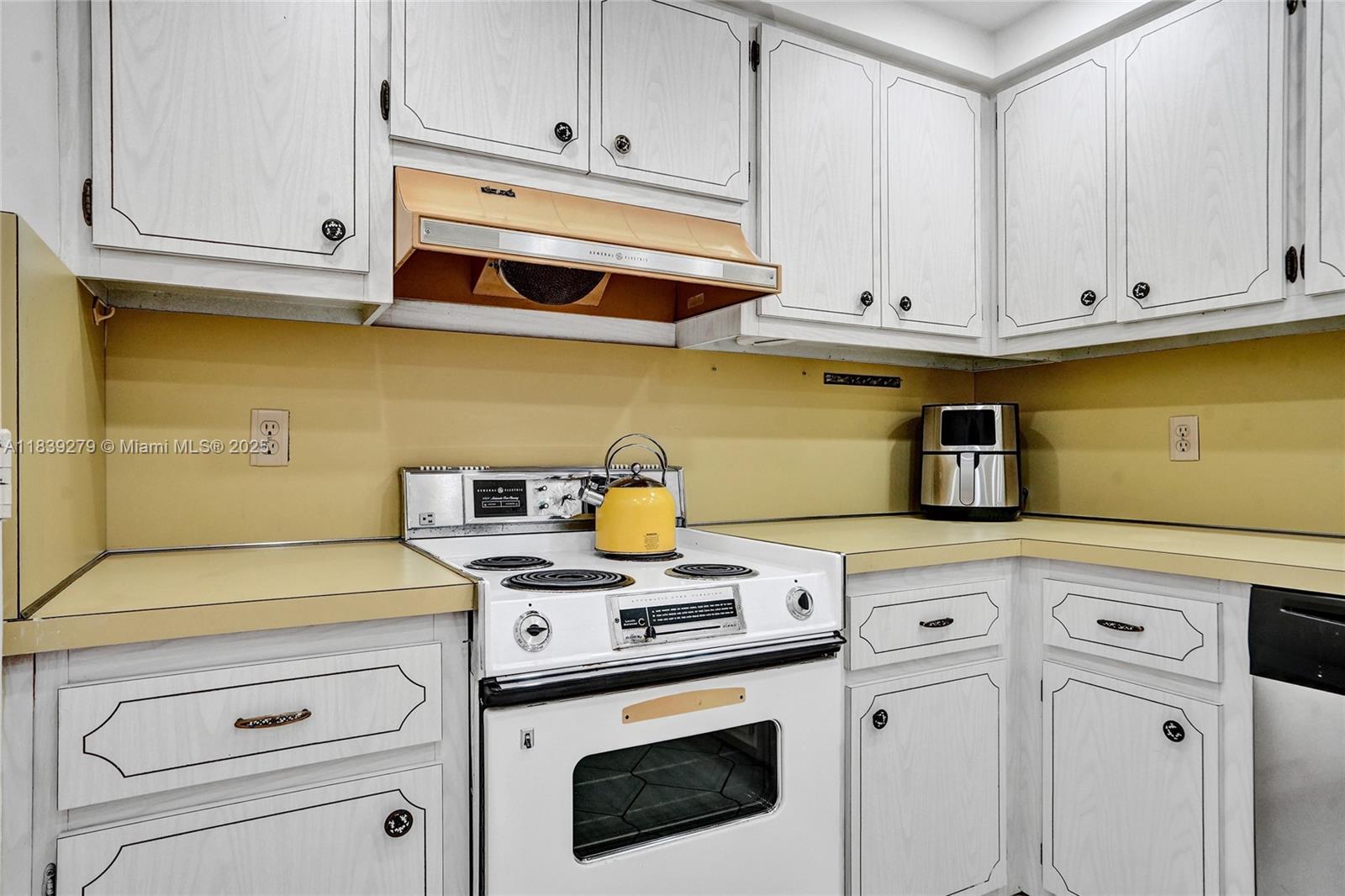 405 North Ocean Boulevard, Unit 815 Pompano Beach, FL 33062 - Photo 15 of 41 a kitchen with white cabinets and white appliances