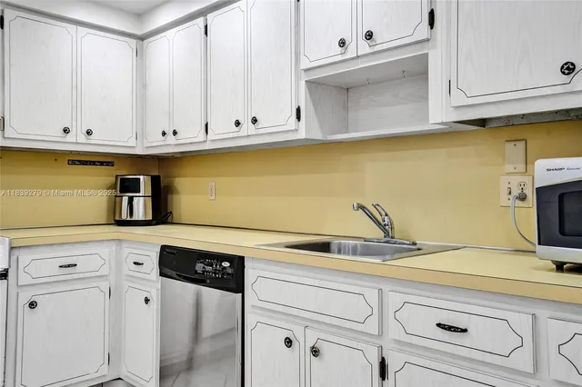 a kitchen with cabinets appliances and a sink