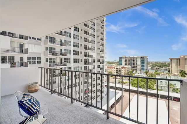a bathroom with a granite countertop sink a toilet a mirror and shower