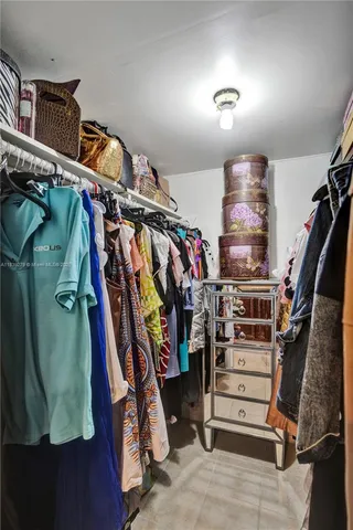 a bedroom with a bed couch and window