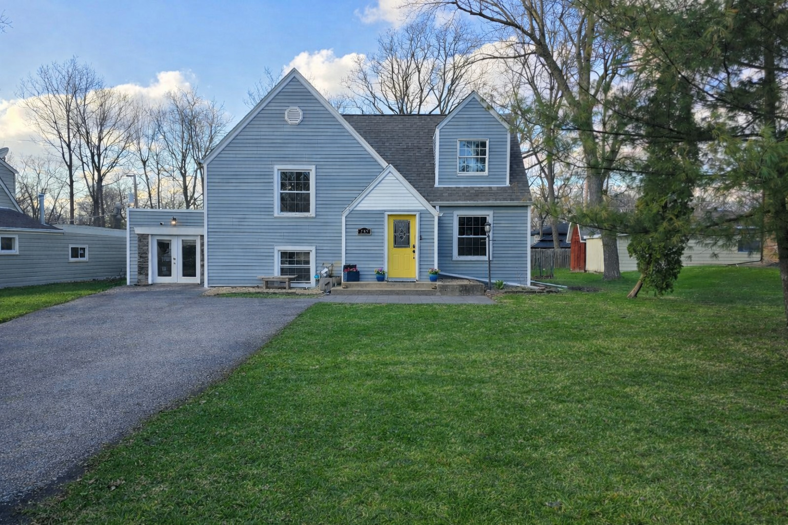 a front view of house with yard and green space