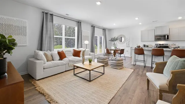 a view of a workspace with furniture and wooden floor