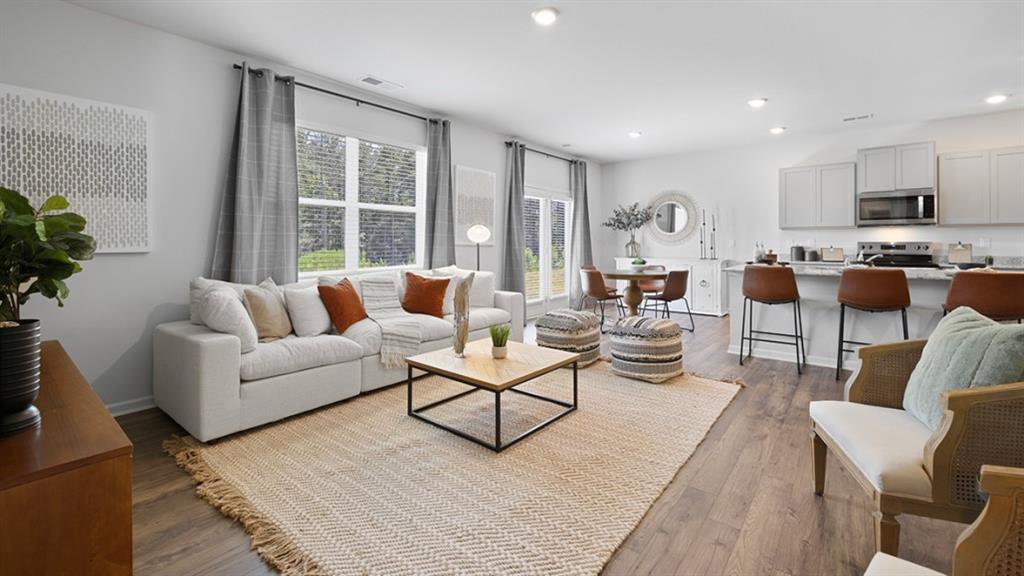 5541 Donamire Way Fairburn, GA 30213 - Photo 16 of 71 a living room with furniture wooden floor and a large window