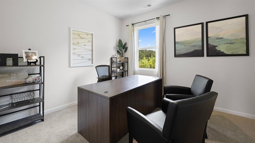 5541 Donamire Way Fairburn, GA 30213 - Photo 17 of 71 a kitchen with a wooden floor and a potted plant