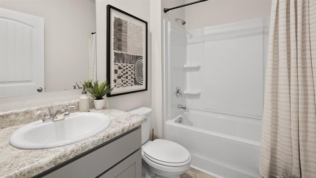 5541 Donamire Way Fairburn, GA 30213 - Photo 19 of 71 a bathroom with a granite countertop sink toilet and shower