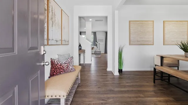 a view of a dining room with furniture and wooden floor
