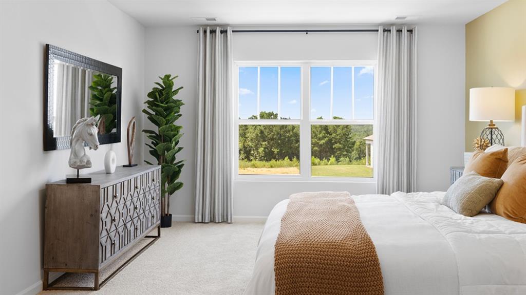 5541 Donamire Way Fairburn, GA 30213 - Photo 21 of 71 a bed sitting in a bedroom next to a window