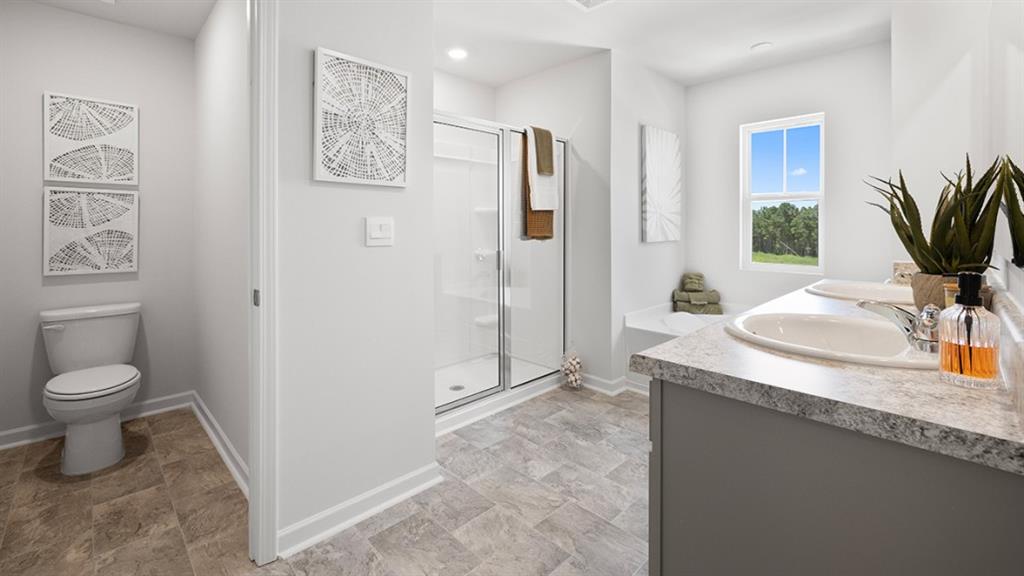 5541 Donamire Way Fairburn, GA 30213 - Photo 26 of 71 a bathroom with a granite countertop sink toilet and shower