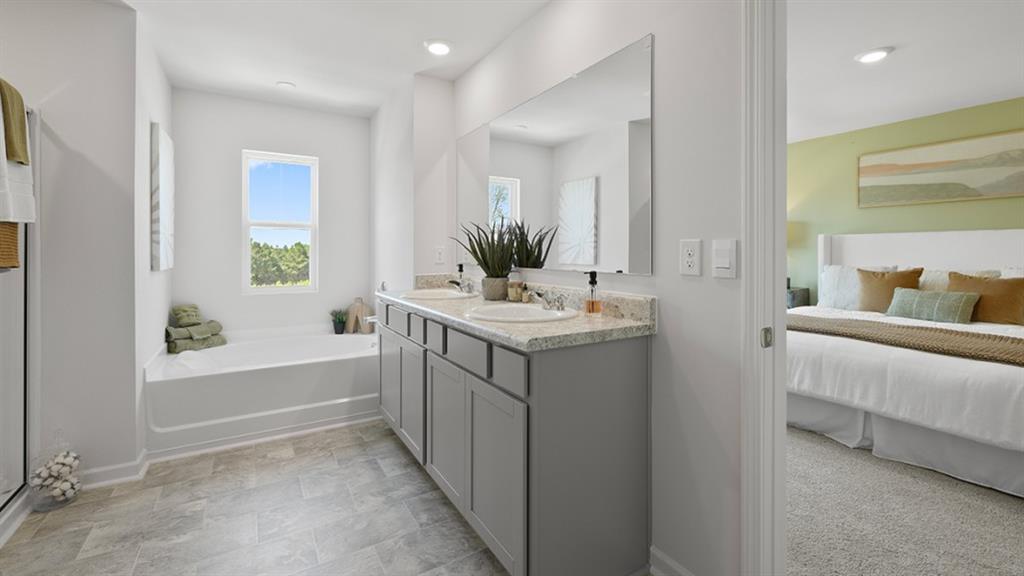 5541 Donamire Way Fairburn, GA 30213 - Photo 27 of 71 a bathroom with a bathtub sink and mirror