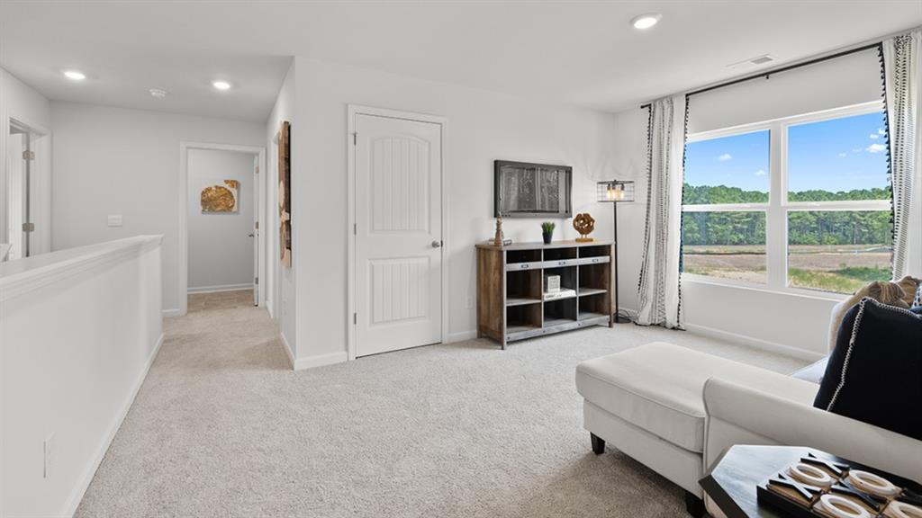 5541 Donamire Way Fairburn, GA 30213 - Photo 34 of 71 a living room with furniture and a large window