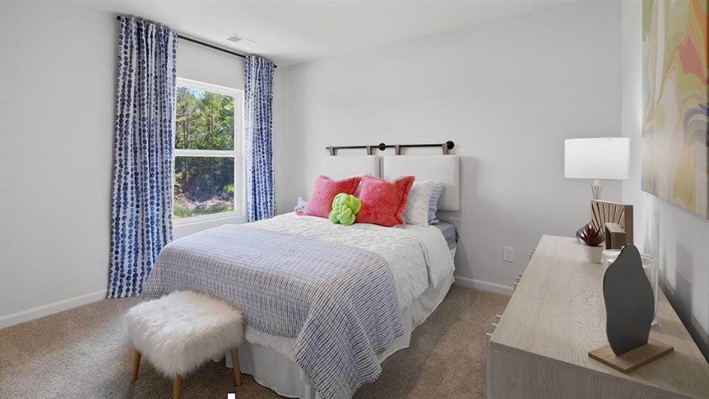 5541 Donamire Way Fairburn, GA 30213 - Photo 37 of 71 a bedroom with a bed and a lamp