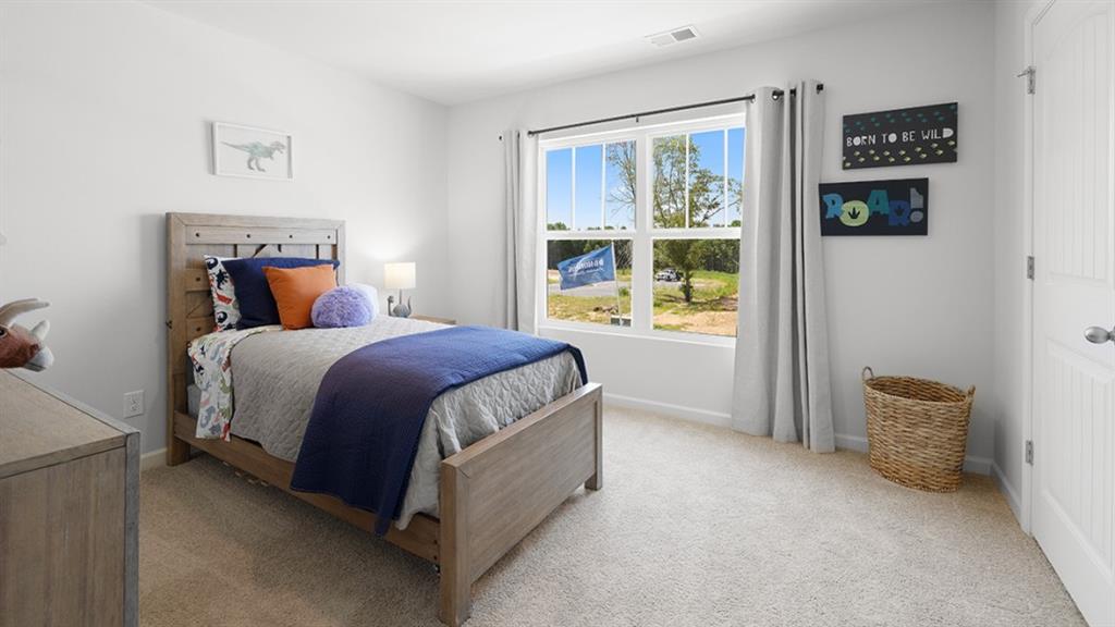 5541 Donamire Way Fairburn, GA 30213 - Photo 40 of 71 a bed sitting in a bedroom next to a window