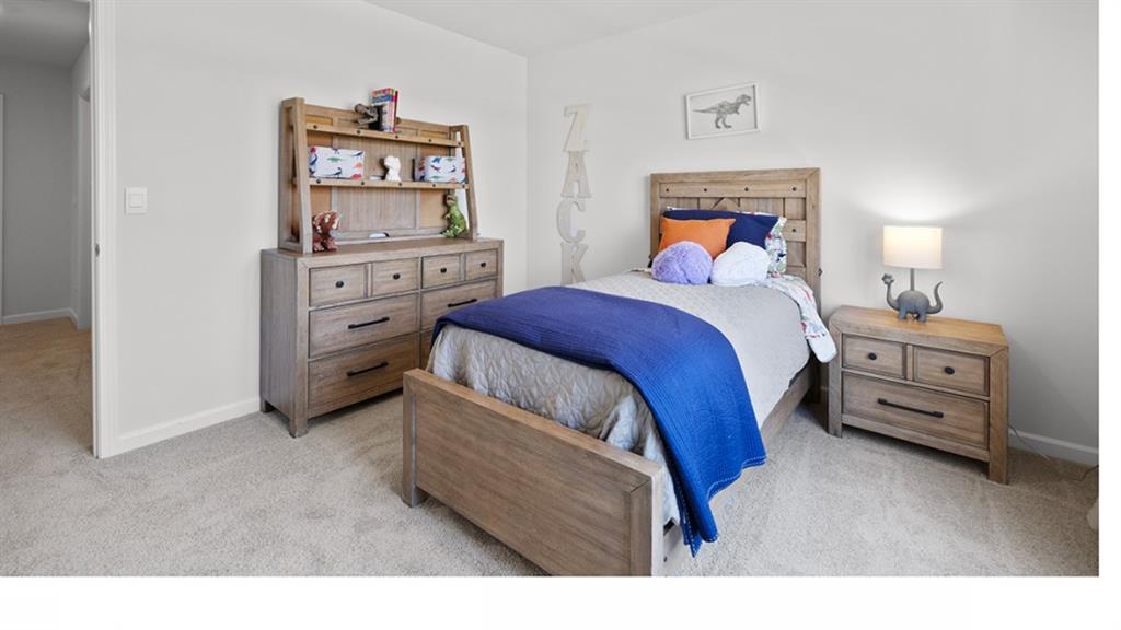 5541 Donamire Way Fairburn, GA 30213 - Photo 41 of 71 a bedroom with a bed and a lamp on dresser