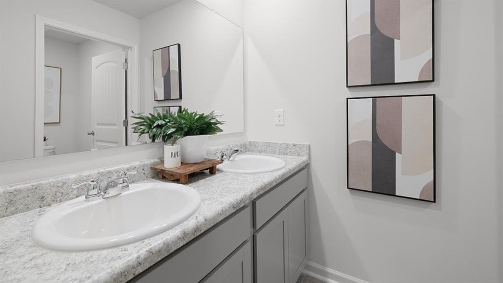 5541 Donamire Way Fairburn, GA 30213 - Photo 45 of 71 a bathroom with a granite countertop sink and a mirror