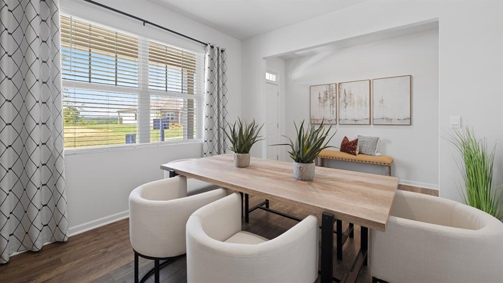 5541 Donamire Way Fairburn, GA 30213 - Photo 5 of 71 a dining room with furniture and wooden floor
