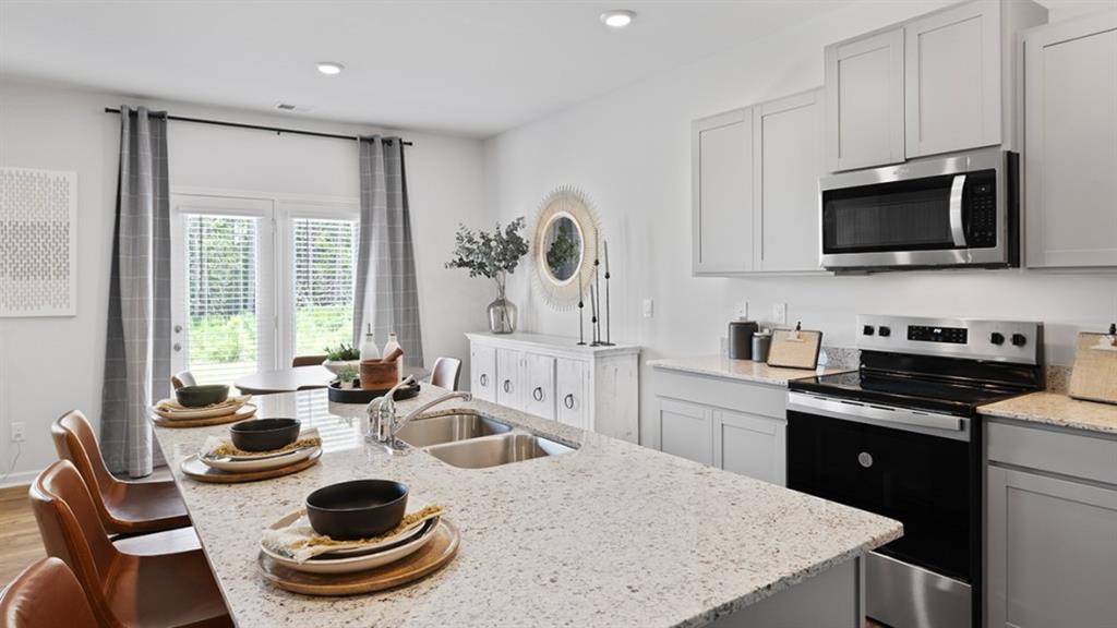 5541 Donamire Way Fairburn, GA 30213 - Photo 8 of 71 a kitchen with a sink a stove and microwave