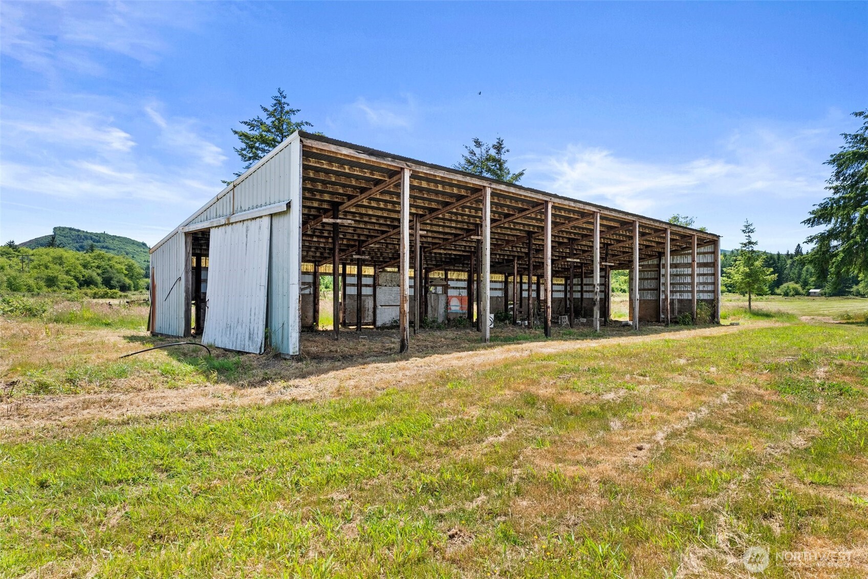 1608 SR 6 Raymond, WA 98577 - Photo 6 of 12 a view of a house with a yard and garage