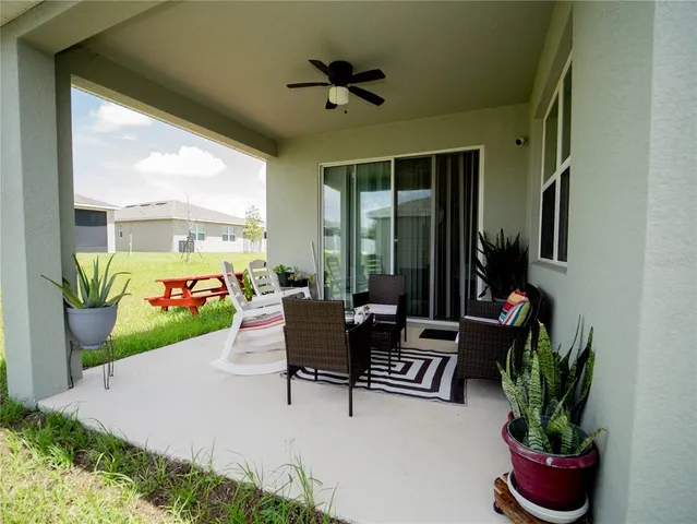 a building outdoor space with patio furniture and potted plants