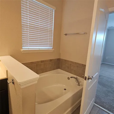 a bathroom with a bathtub and a window