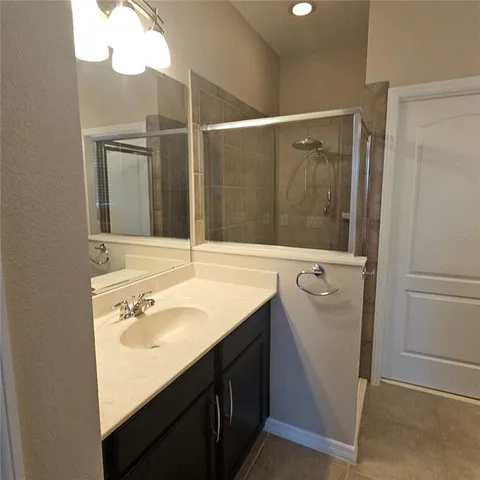 a bathroom with a sink vanity and a mirror