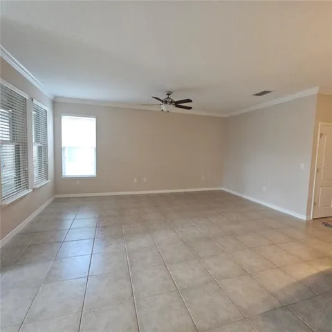a view of a livingroom with a ceiling fan and window