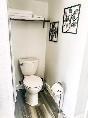 a white toilet sitting next to a white toilet