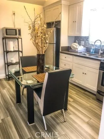 a view of a kitchen with stainless steel appliances granite countertop a stove and a refrigerator
