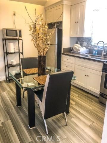 214 Walnut Avenue Huntington Beach, CA 92648 - Photo 8 of 14 a view of a kitchen with stainless steel appliances granite countertop a stove and a refrigerator