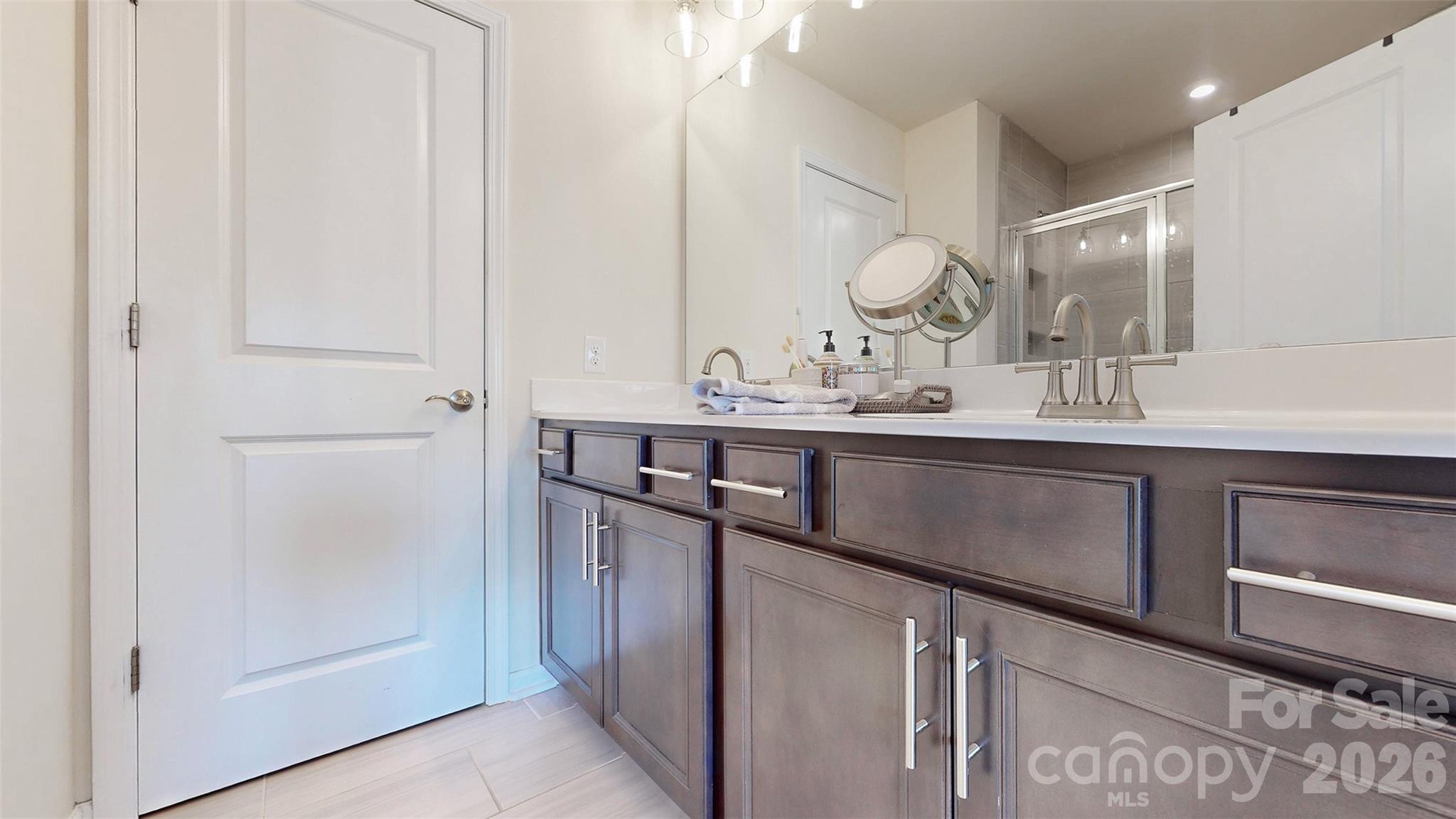 827 Canoe Song Road Fort Mill, SC 29708 - Photo 25 of 33 a bathroom with a sink a mirror and a shower