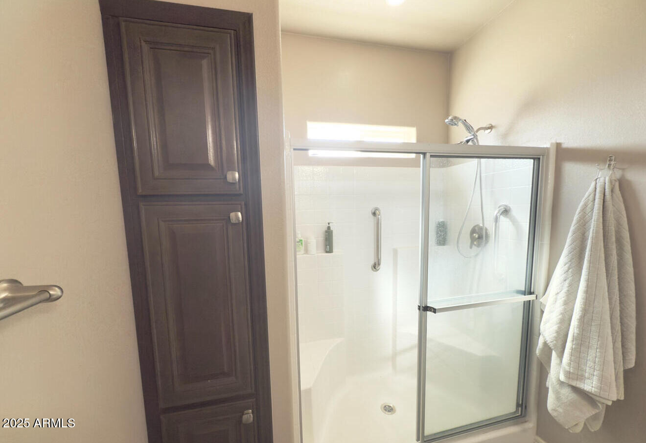 8865 East Baseline Road, Unit 614 Mesa, AZ 85209 - Photo 9 of 15 a bathroom with a glass shower door and a sink