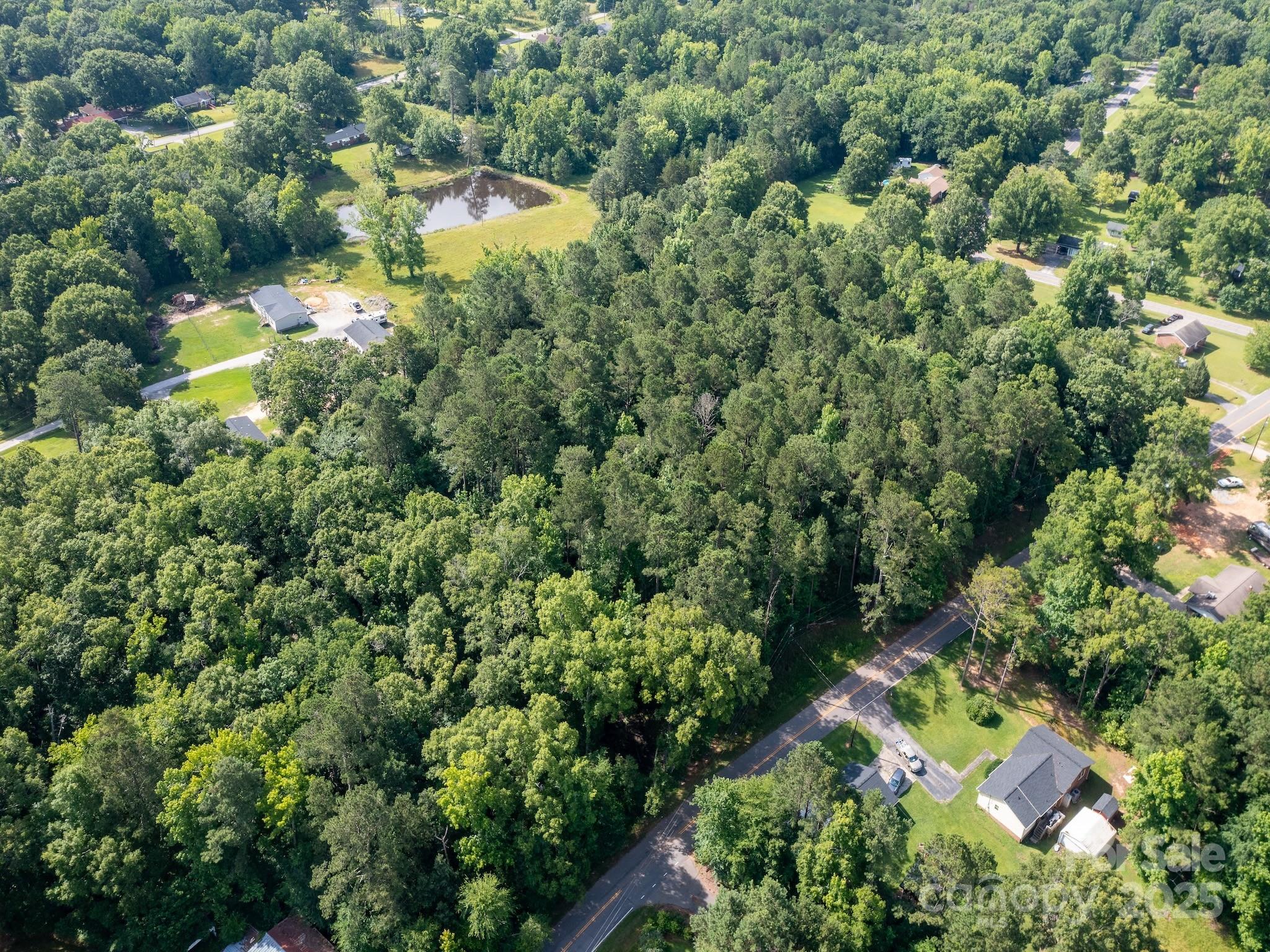 an aerial view of a residential houses with yard and swimming pool