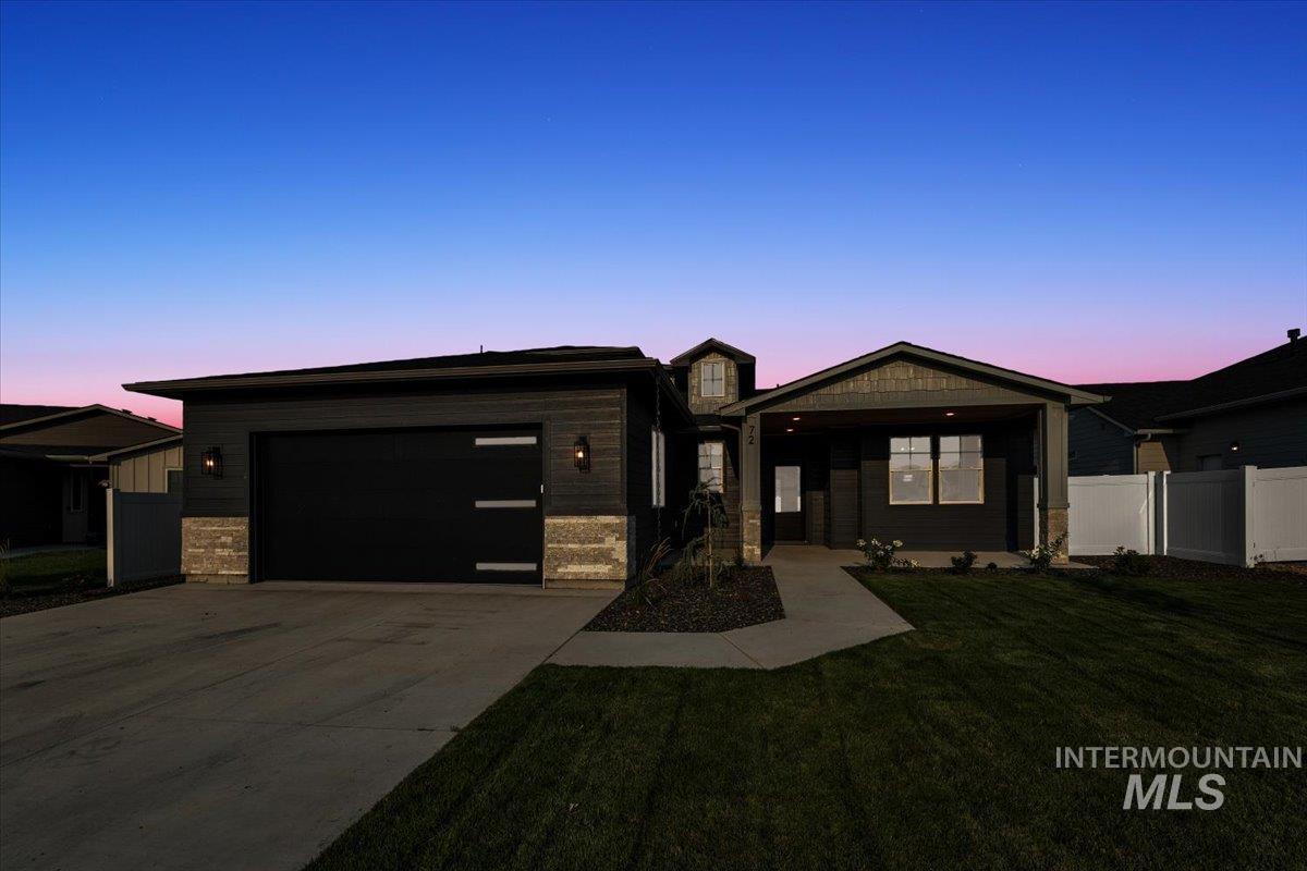 72 South Ravine Way Nampa, ID 83687 - Photo 40 of 48 Modern single-story residence with a covered entry, dark horizontal siding, and stone accents