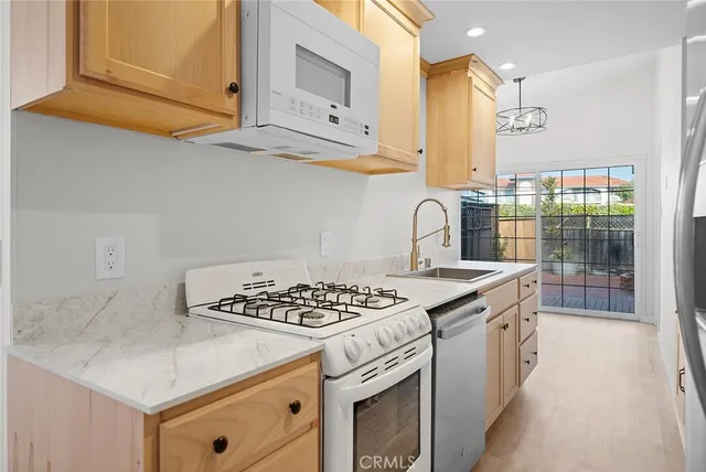 a kitchen with stainless steel appliances granite countertop a sink stove and cabinets
