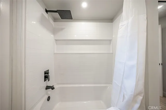 a bathroom with a sink toilet vanity and shower